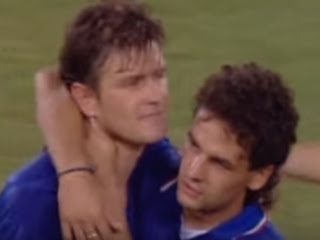 Roberto Baggio consoles Aldo Serena (left) after  Italy's defeat in the semi-final