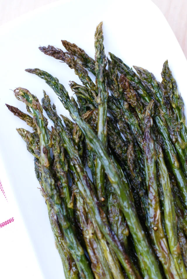 Roasted Asparagus is made by coating fresh asparagus with olive oil, salt, and pepper, and then roasting it in the oven until it is perfectly tender and golden brown.  You will never steam asparagus again!