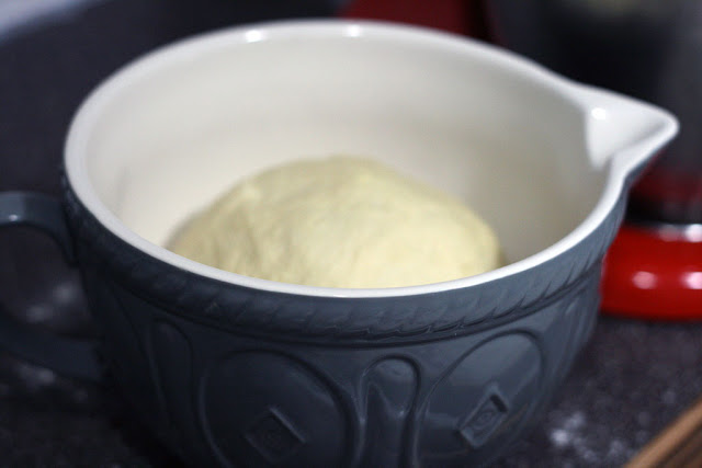 Dough sitting in an oiled  mason cash bowl