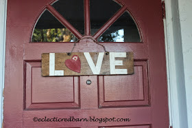 Eclectic Red Barn:  LOVE sign hanging at door with barbed wire hanger