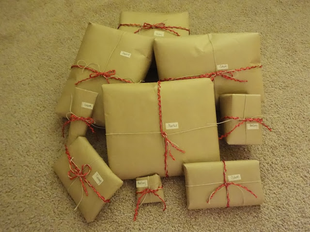 Presents wrapped in brown parcel paper, tied with hemp cord and red string