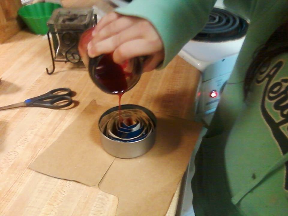 She then poured the hot candle wax around the coils.