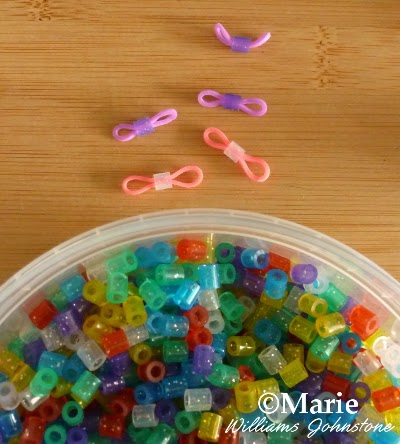 Lots of different perler bead colors and how they fit onto rubber bands