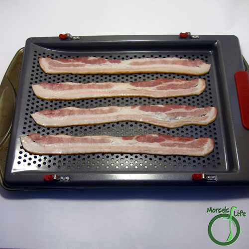 Morsels of Life - Crispy Bacon Strips Step 2 - Lay strips out on a cooling rack or other oven safe surface allowing the grease to drain away.
