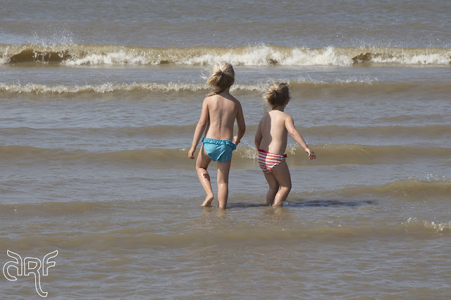 little girls playing in the sea