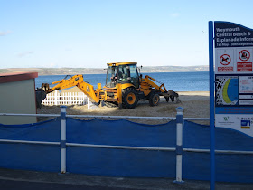 Digger digging donkey stop on Weymouth Beach.