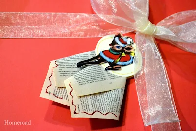 Rudolph bookpage ornament on a gift