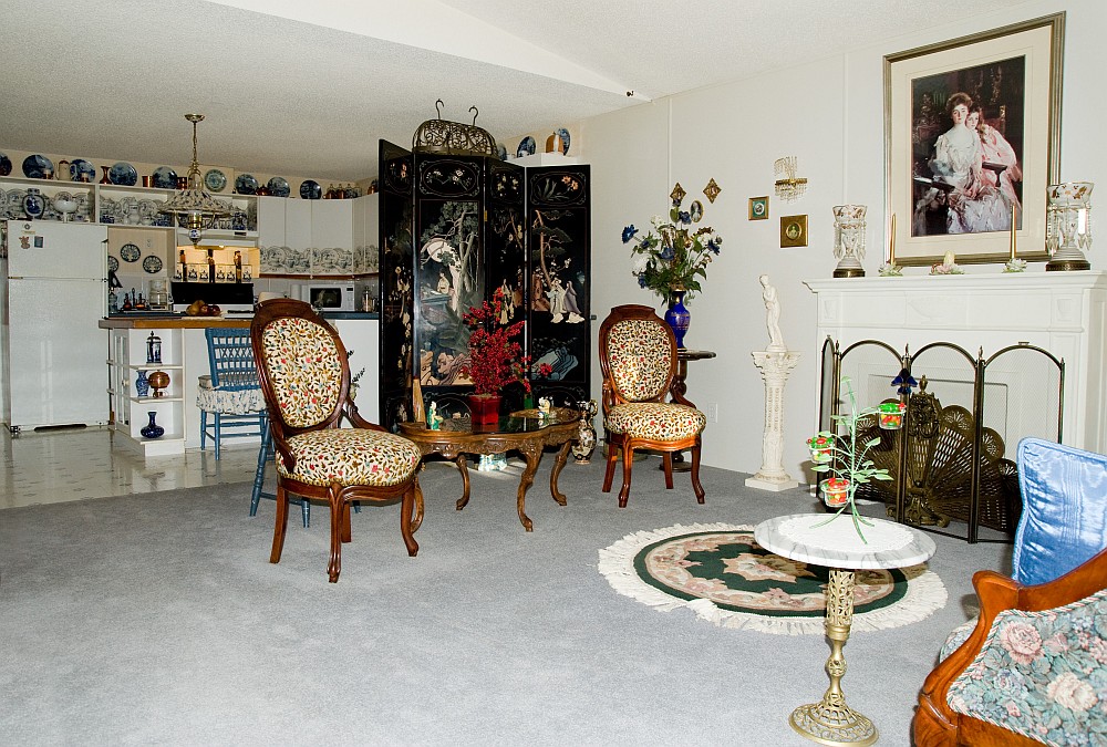 Par of a large living room open to a kitchen with island.