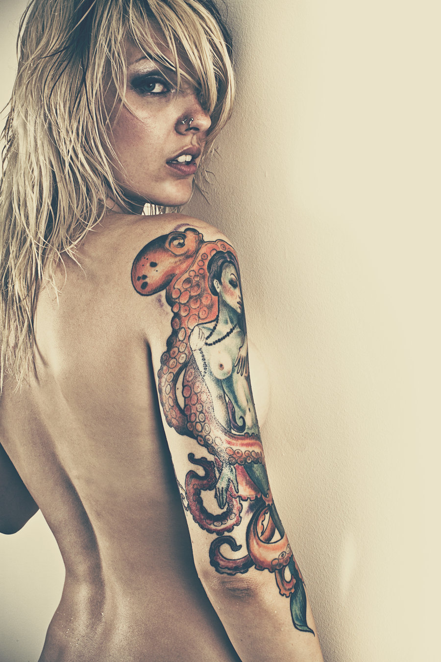 Nude women with sleeve tattoos
