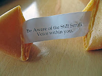 Fortune cookie with the message Be aware of the still small voice within you