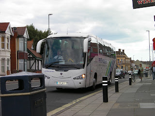 large coach in city street