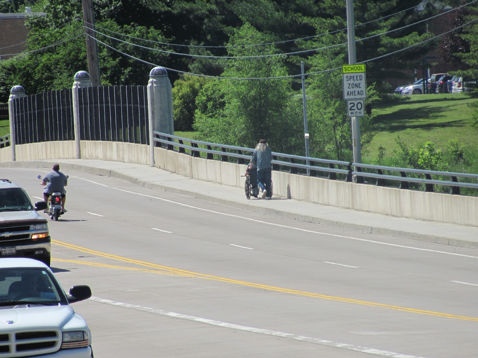 Lensing and Shuttering Wheelchair Crossing a Bridge