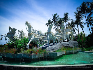 Front Side View Of Krishna's Chariot Statue In The Middle Of A Garden Pond At Tangguwisia Village, North Bali, Indonesia