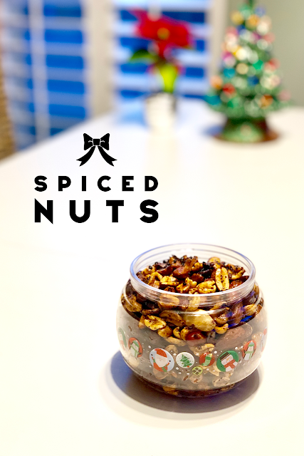 jar of spiced nuts sitting on a white table