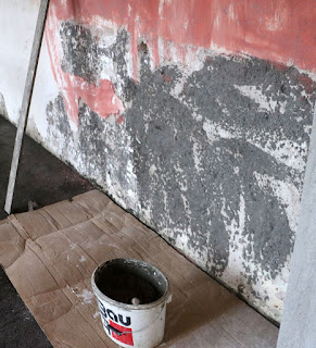 Ready to put the final cement on these damaged areas of wall Ready to put the final cement on these damaged areas of wall