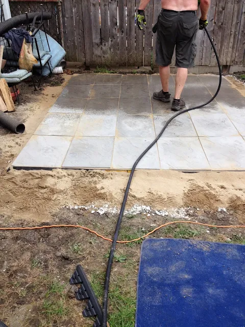 spraying down paver lock