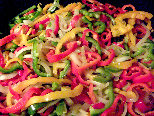pan of frying peppers and onions