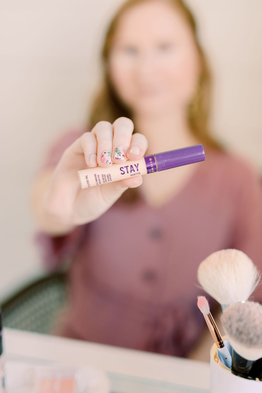 st pete blogger amanda burrows is holding out her tube of Rimmel Stay Matte Concealer in Vanilla. 