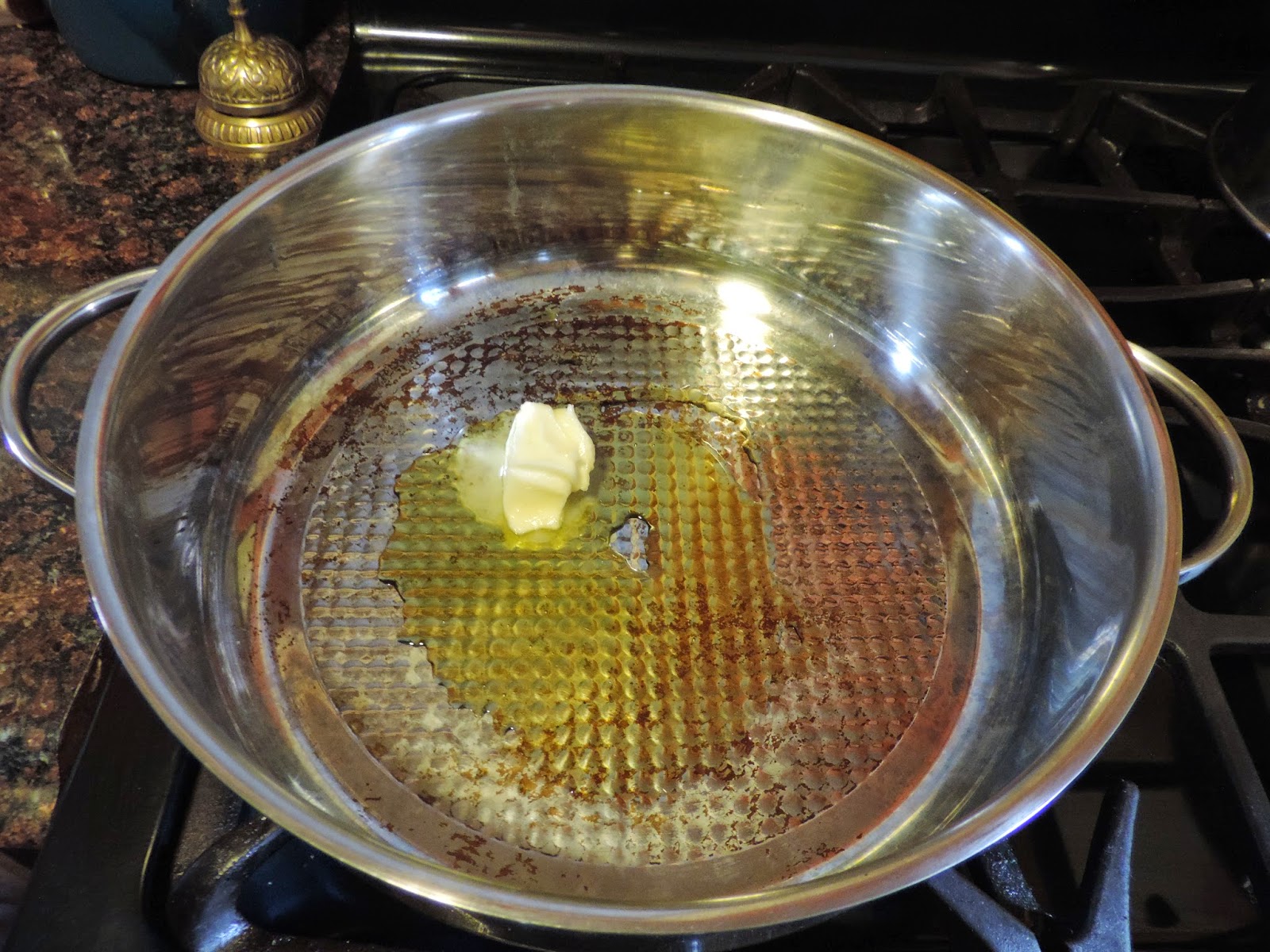 Butter and oil being added to a pan.  