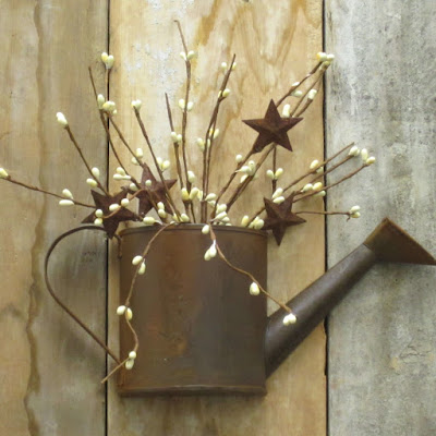 http://www.outerbankscountrystore.com/rusty-half-watering-can-wall-decor/