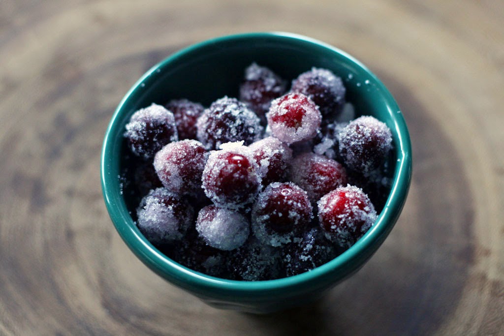 Bowl of homemade candied cranberries that look like ice-frosted berries.