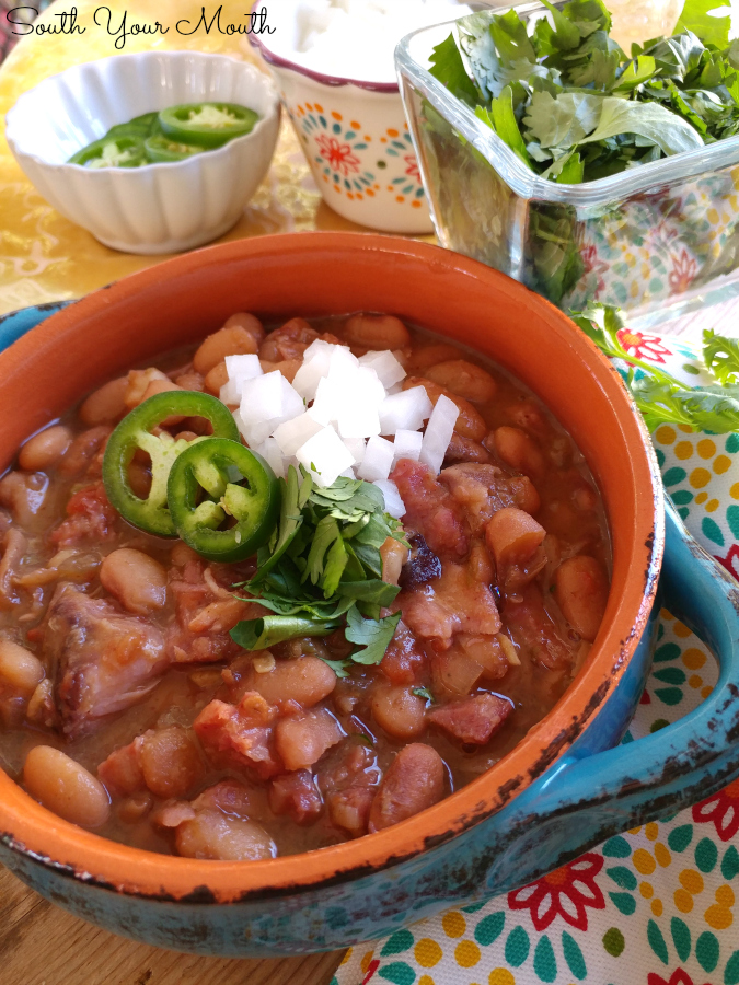 Mexican Borracho Beans cooked low and slow with pinto beans, pork, spices and beer. THE PERFECT side dish to your next Mexican feast!