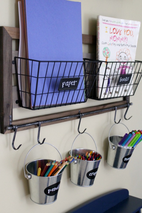 Organized art station for kid's art and craft supplies: Use hanging metal buckets for easy pencil, crayon and marker storage
