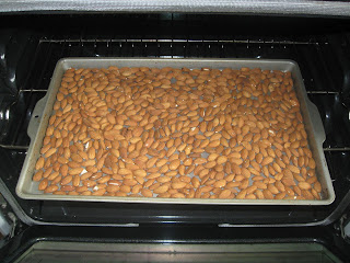 Almonds spread out on a baking sheet