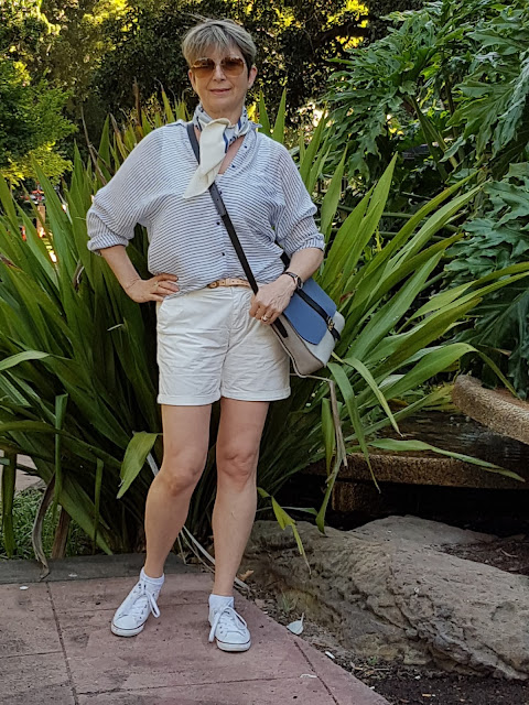 White shorts pared with sneakers, a blouse and vintage Pierre Cardin scarf