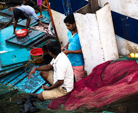 solitude fishermen fishing boat nets contemplating sassoon docks mumbai india