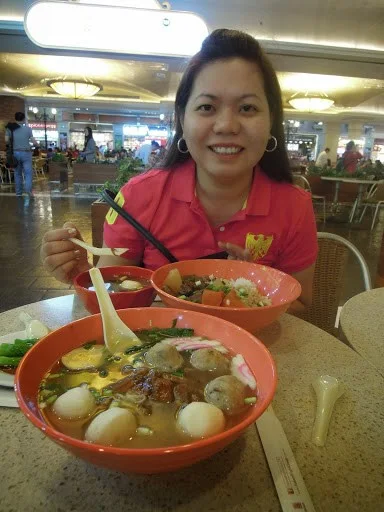 A travel blogger eating dumpling noodle soup for lunch at the food hall of The Venetian Hotel Macao