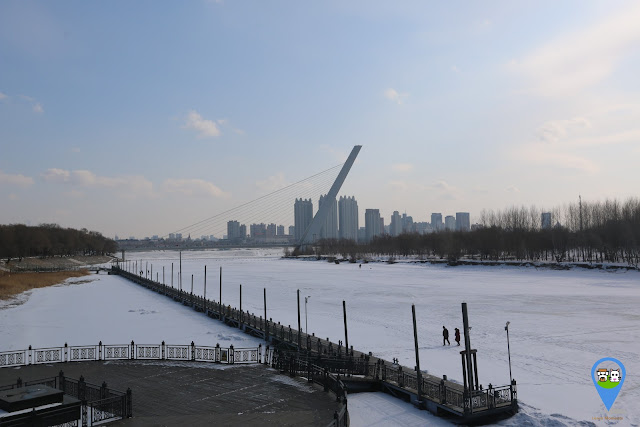 Heading back to Harbin downtown and overlooking at the frozen lake at Harbin in Heilongjiang province, China Heading back to Harbin downtown and overlooking at the frozen lake at Harbin in Heilongjiang province, China