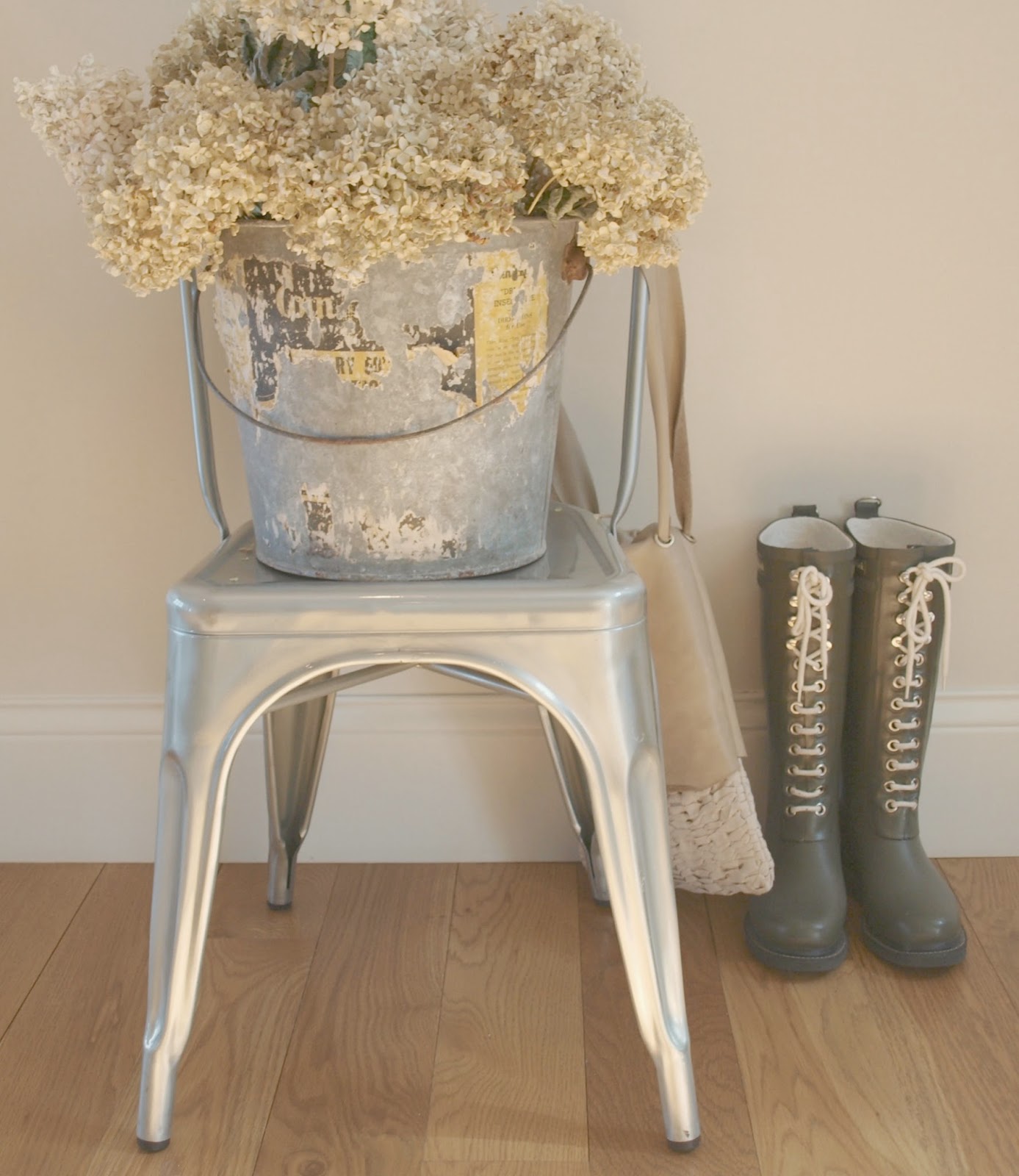 Tolix chair, galvanized bucket, hydrangea, and wellies Hello Lovely Studio