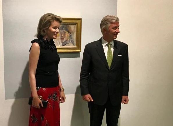 Queen Mathilde wore Natan floral skirt and Delphine Nardin Gold Earrings, The Queen carried Diane von Furstenberg black Elaphe clutch