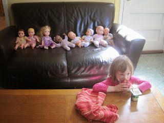 Babies on the sofa, 4-year-old at table with apple and yogurt.