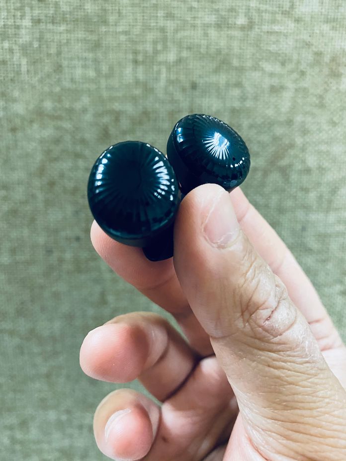 A pair of Realfit Gopods E5 Earbuds