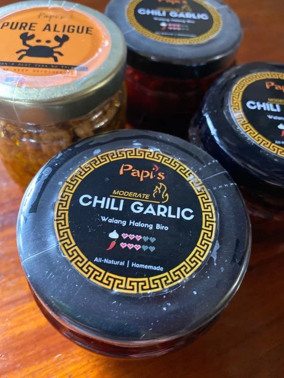 Bottles of Papi's Chili Garlic and aligue or crab fat