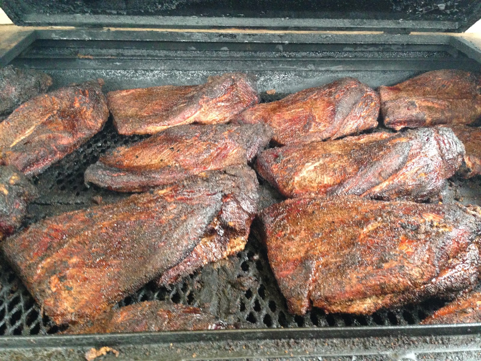 Man Up Tales of Texas BBQ™ Brisket & sausage in the smokers at Hays