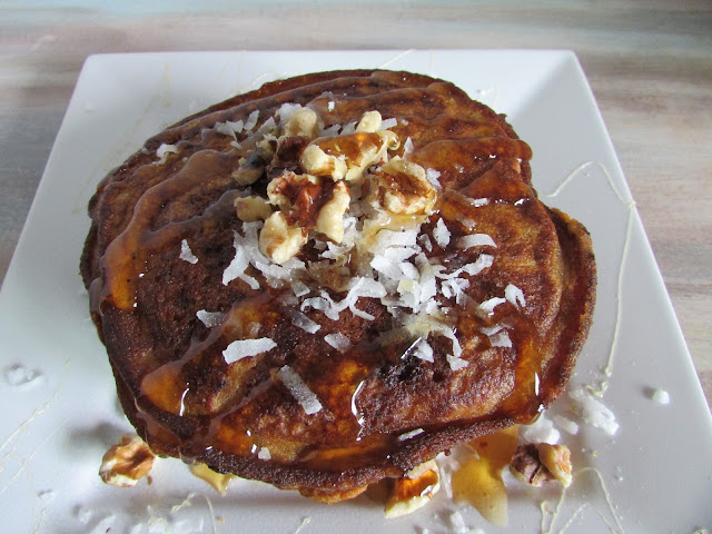 pumpkin pancake on a plate with coconut and walnuts