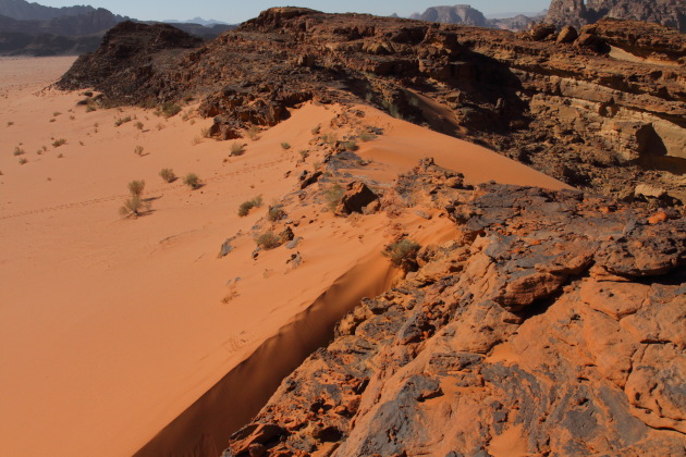 Red sand dunes of Wadi Rum amidst the mountains