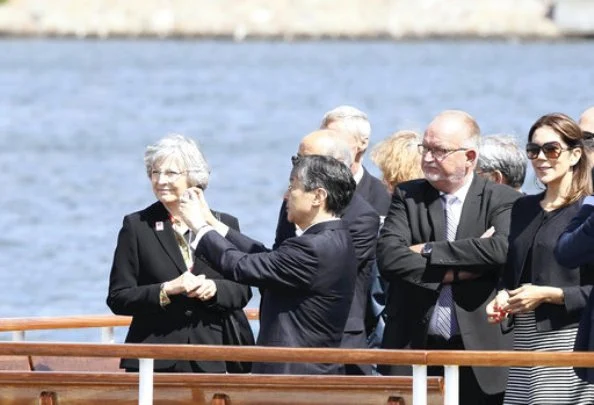 Crown Prince Naruhito of Japan on a boat trip with Crown Princess Mary of Denmark. Princess wore Prada coat and Prada skirt