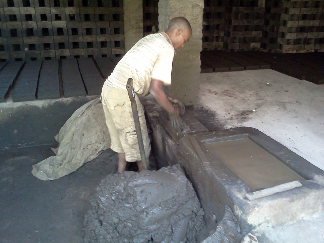 Alternative Building Construction : Making production clay bricks by hand.