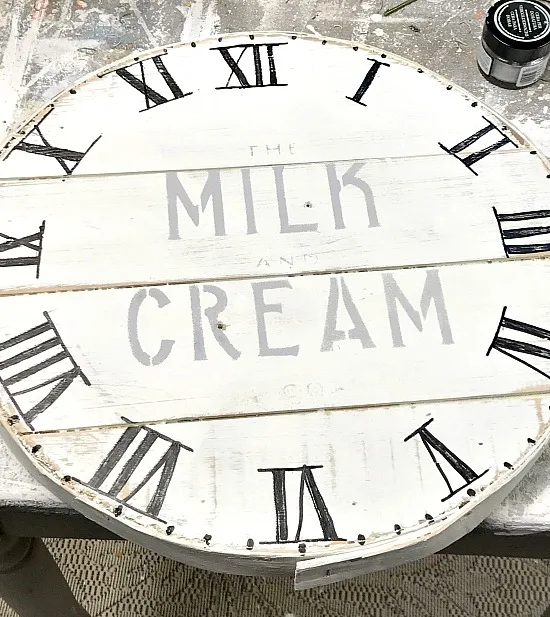 stenciling a milk and cream stencil on a cheese box