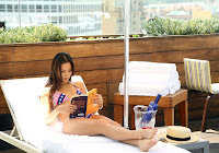 Jamie Chung reading a book in a bikini