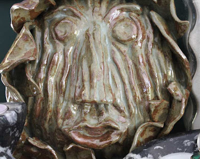 wood bark sculpted face in clay glazed