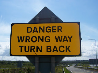 wrong way sign turn back
