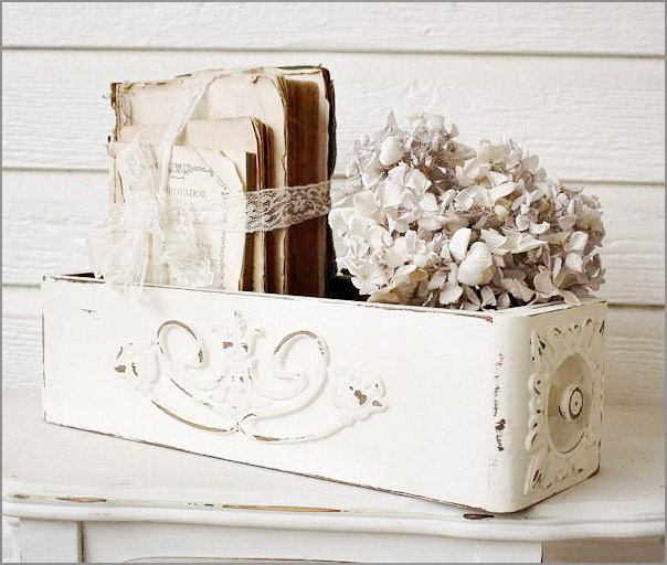 This renovated drawer with rustic white paint adds a vintage touch to the table.