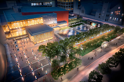 Birdseye view of a rebuilt plaza with some trees, some open space with lots of poles, and an outdoor performance area