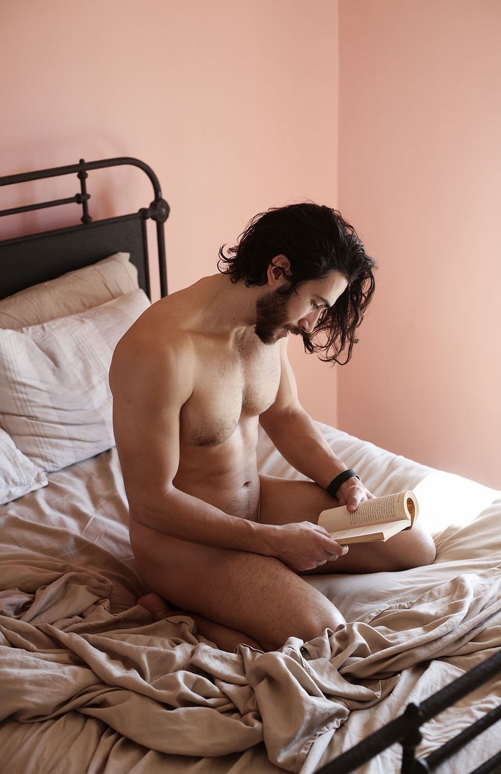 Peep this photo series of naked guys reading in bed.