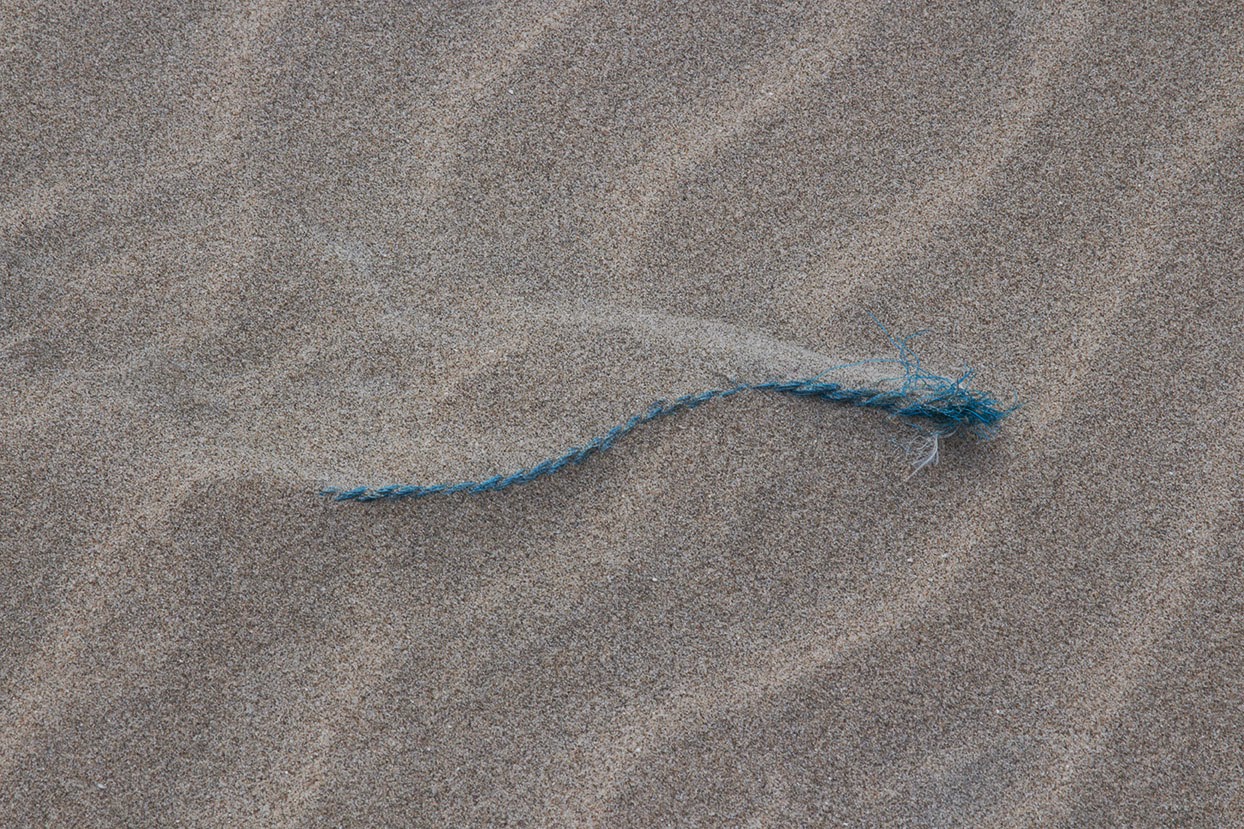 blue rope in sand